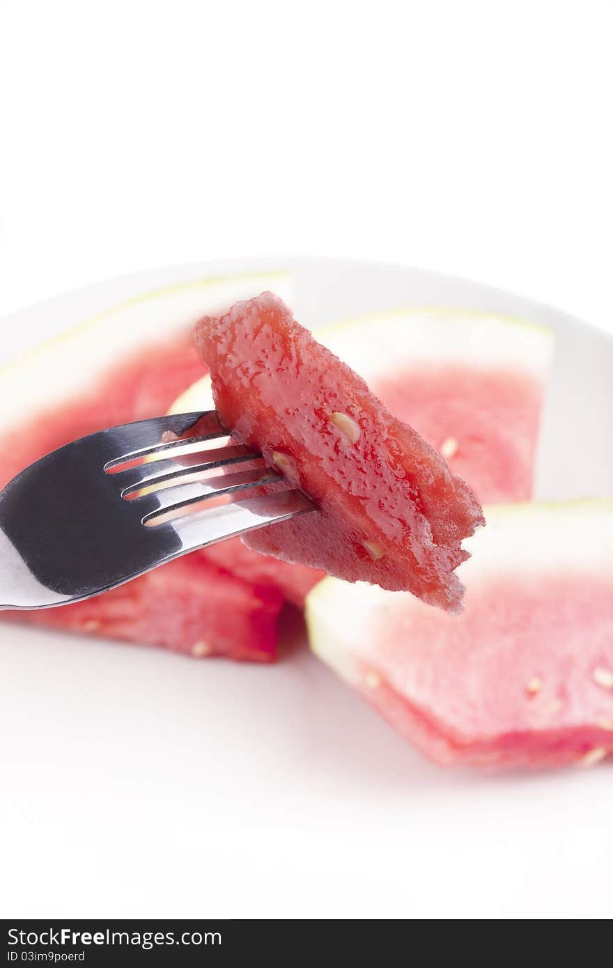 Studio-shot of a fork with a piece of watermelon, isolated on white.