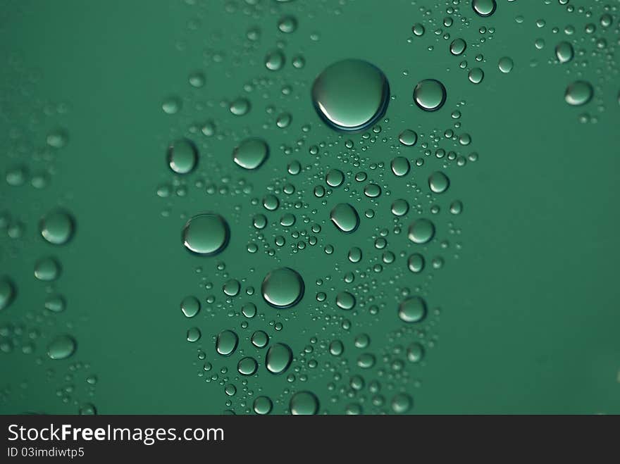 Water drops on green background