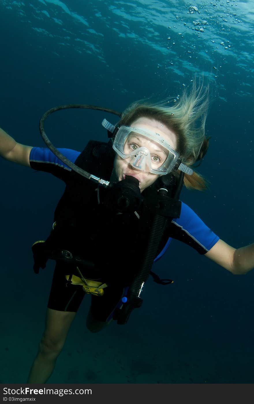 Blond female scuba diver in ocean