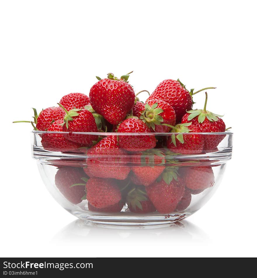 Fresh strawberries in a glass dish on white.