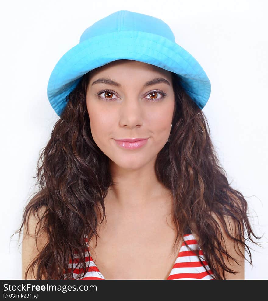 Girl with hat smiling in front of white background. Girl with hat smiling in front of white background