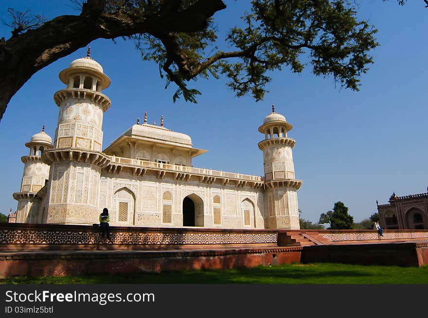 Visitors sit in front of Itimad-ud-Daula's Tomb or better known as Baby Taj in Agra, India. Visitors sit in front of Itimad-ud-Daula's Tomb or better known as Baby Taj in Agra, India.