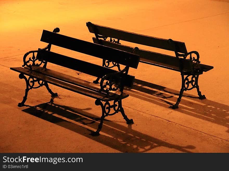 Benches under the glowing light of street lamp. Benches under the glowing light of street lamp