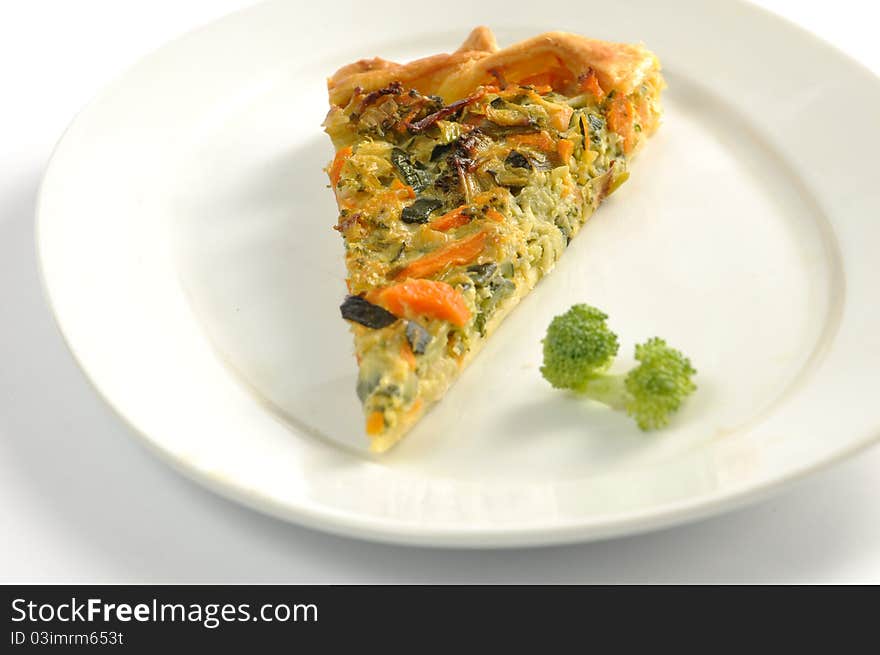 Slice of Vegetable pie on a white dish