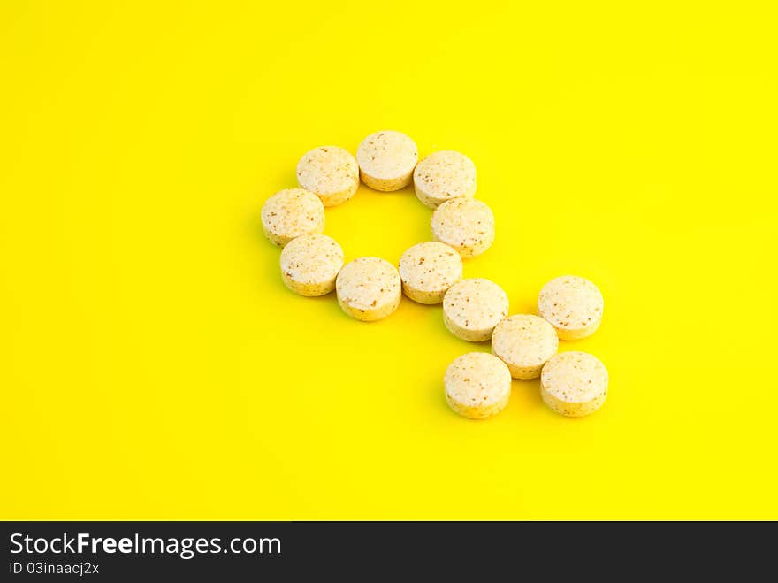 Dietary supplements on yellow background, close-up shot.