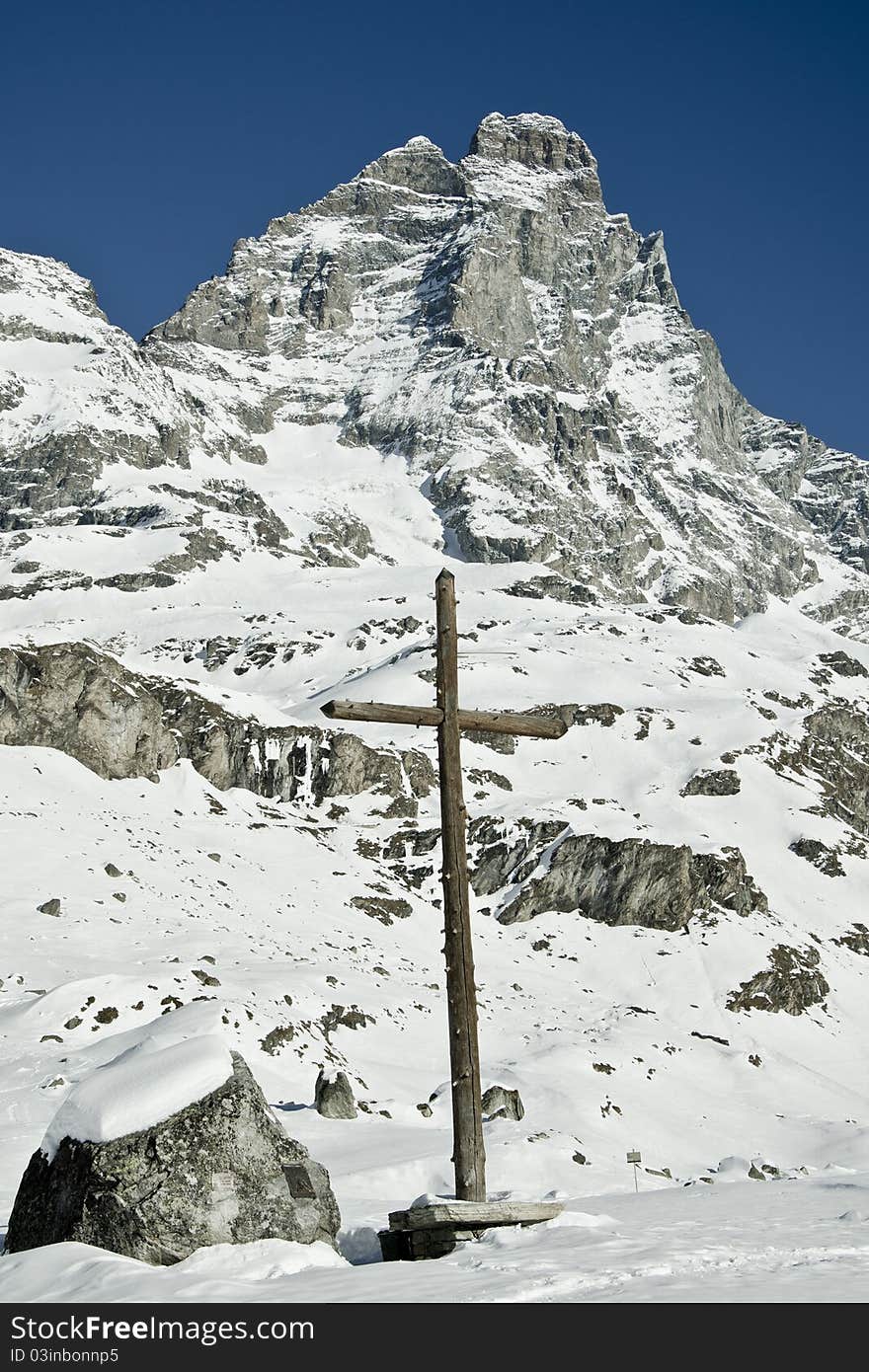 Cross under mountain