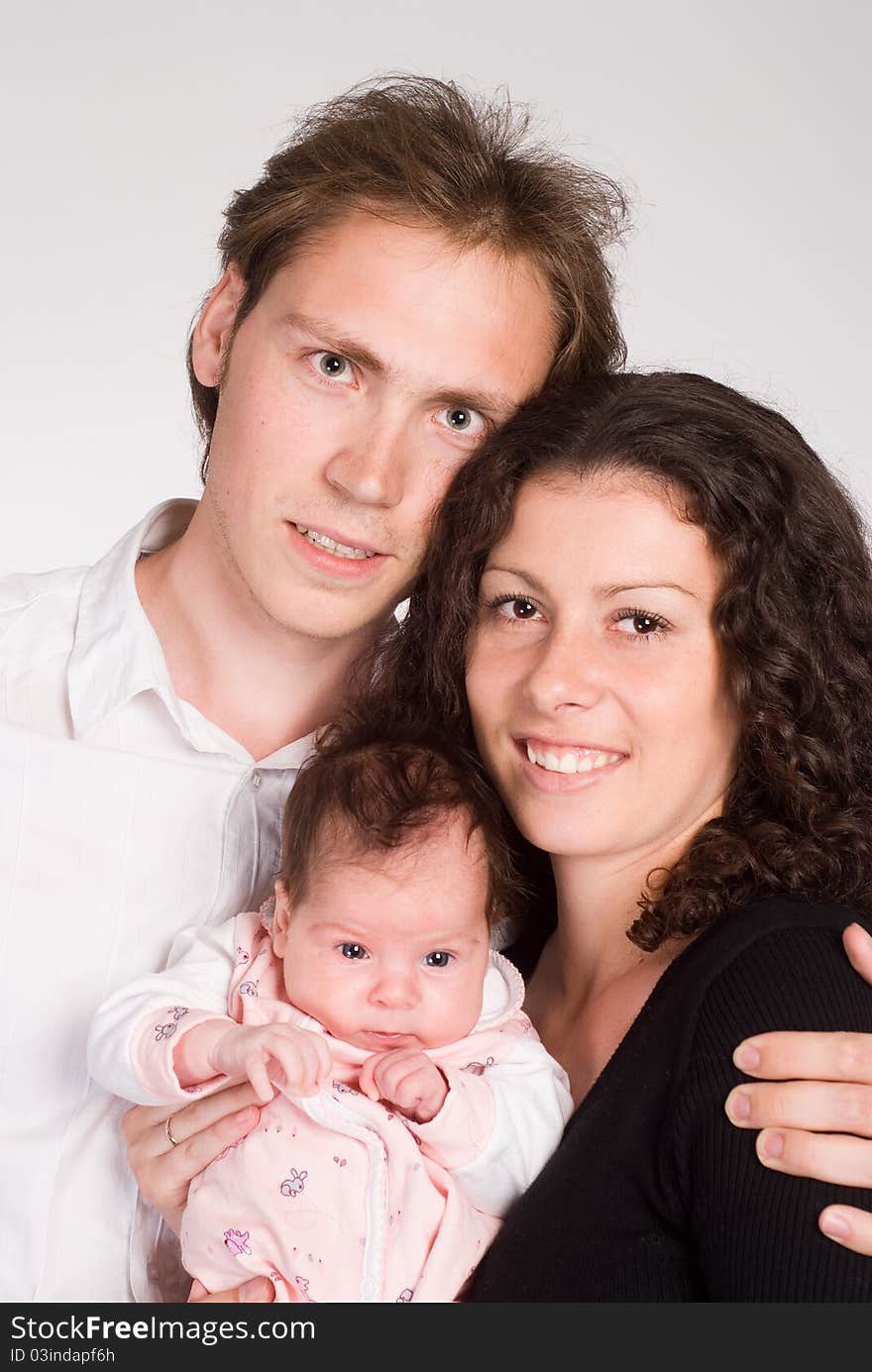 Happy young family with newborn on a white. Happy young family with newborn on a white