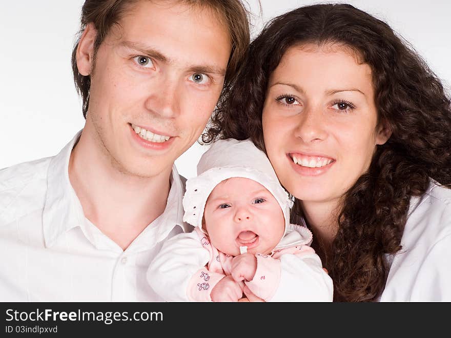 Happy young family with  newborn on a white. Happy young family with  newborn on a white