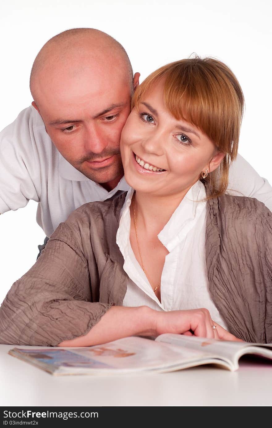 Portrait of a nice couple reading at table. Portrait of a nice couple reading at table