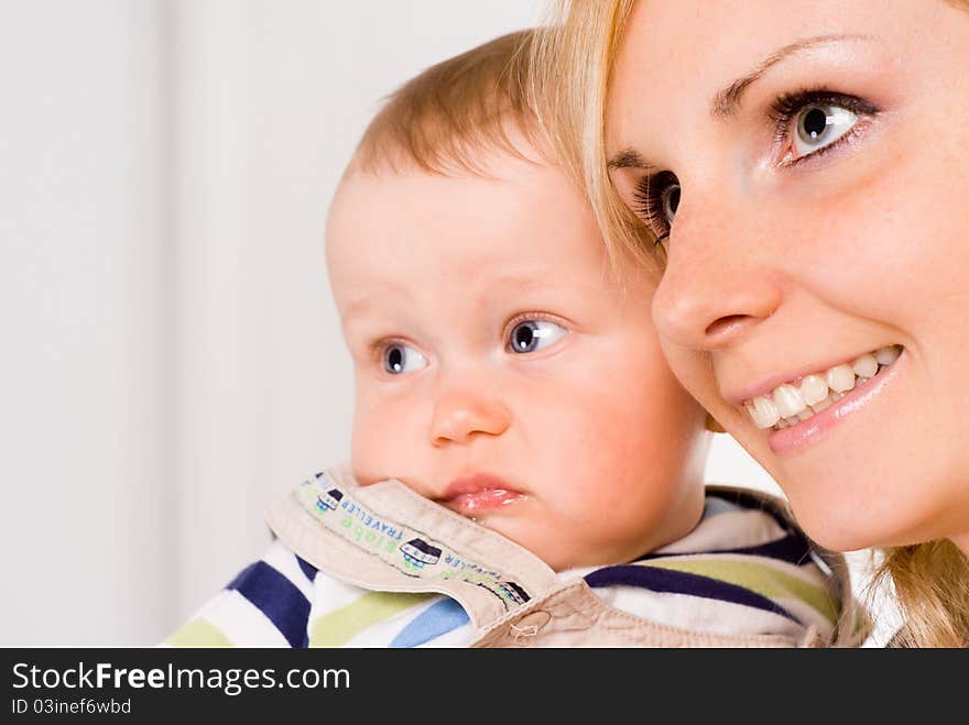 Cute mom with her baby on a white. Cute mom with her baby on a white