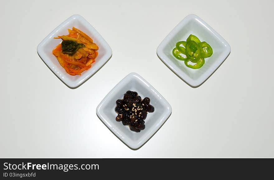 Kimchi, Black beans with sesame and paprika placed triangular. Kimchi, Black beans with sesame and paprika placed triangular.