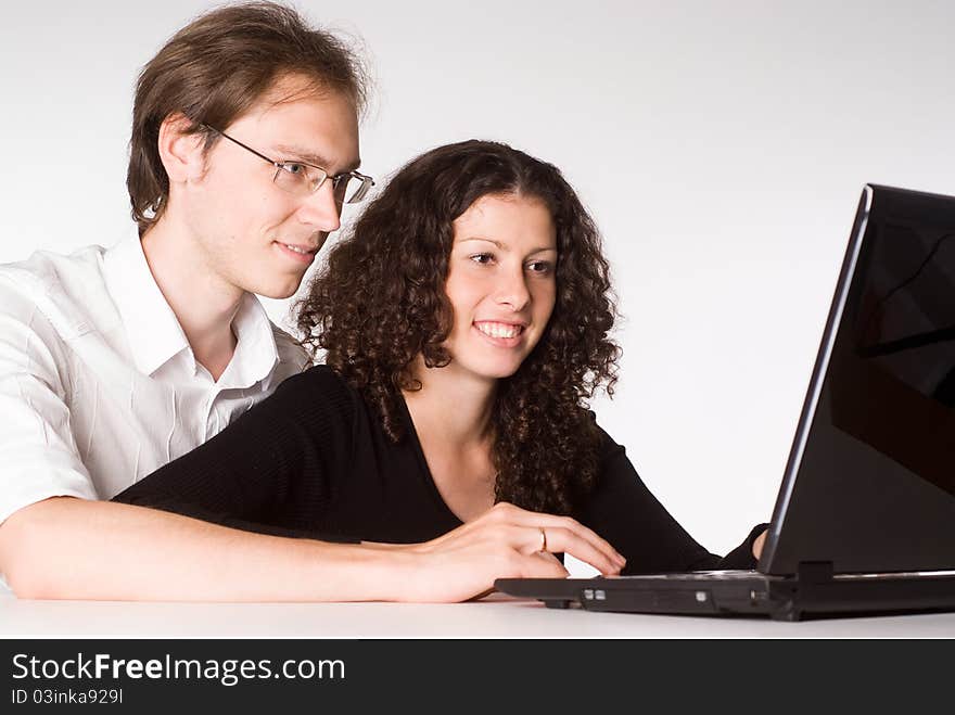 Happy young couple works with a laptop. Happy young couple works with a laptop