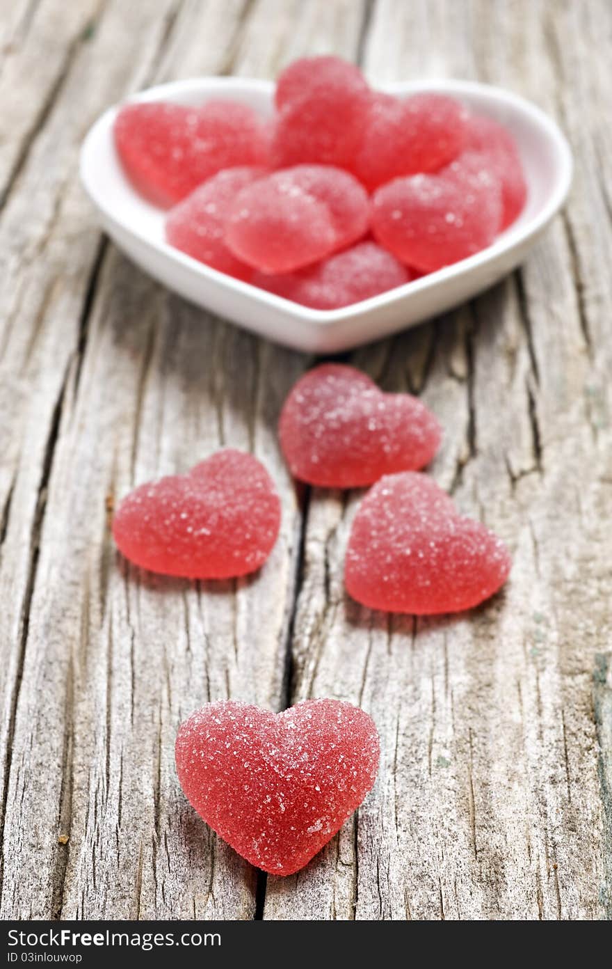 Red heart shaped jelly sweets on a rustic background. Red heart shaped jelly sweets on a rustic background