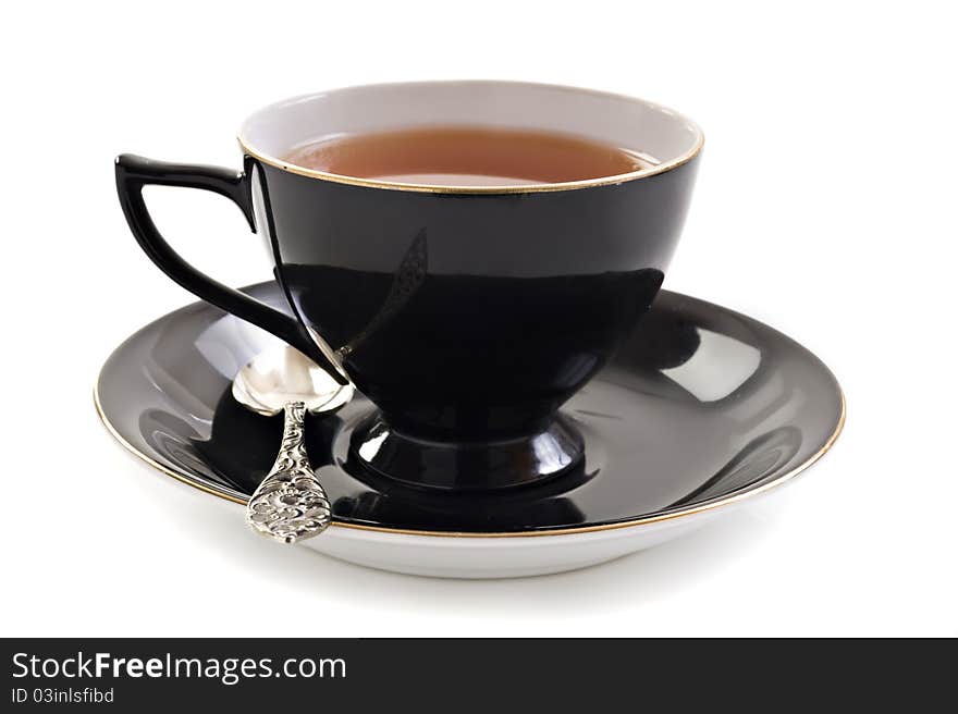 Black tea cup on a white background with space for text. Black tea cup on a white background with space for text