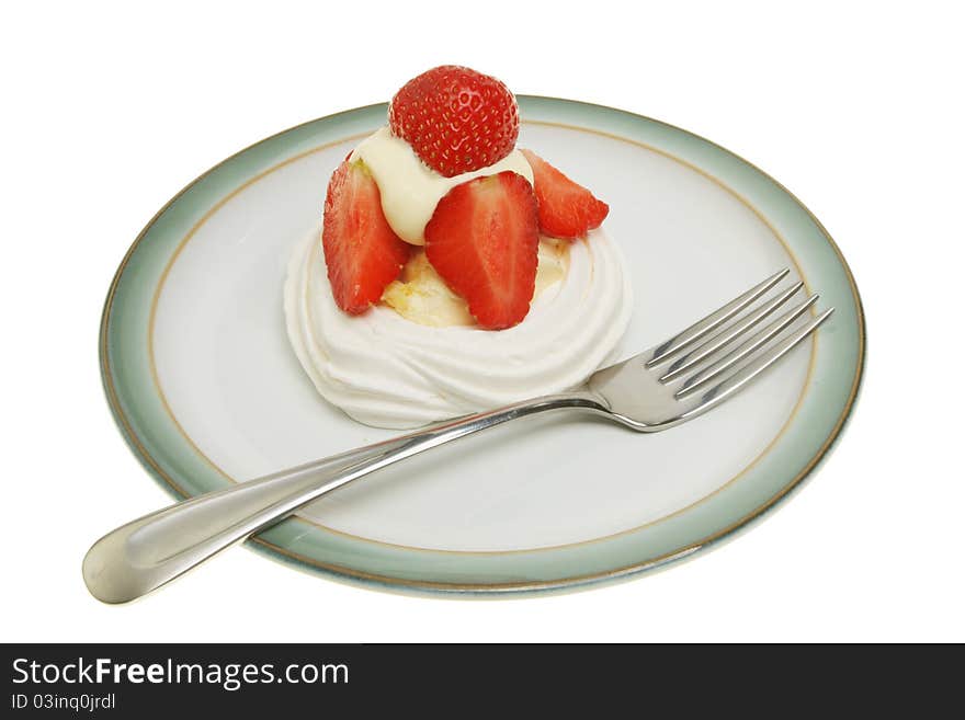 Strawberry and cream meringue on a plate with a fork isolated against white. Strawberry and cream meringue on a plate with a fork isolated against white