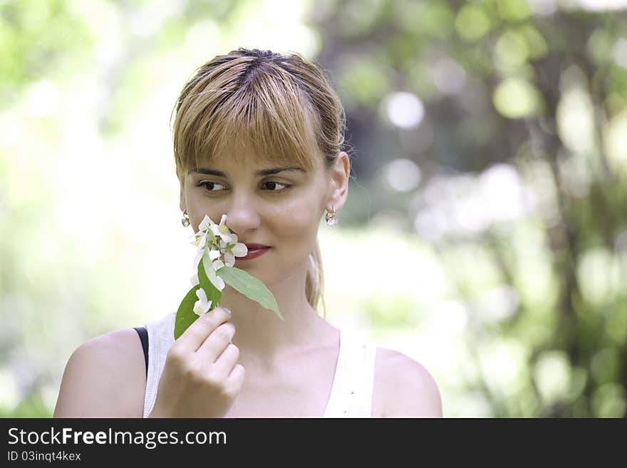 Beautiful Young Woman Smelling Flower