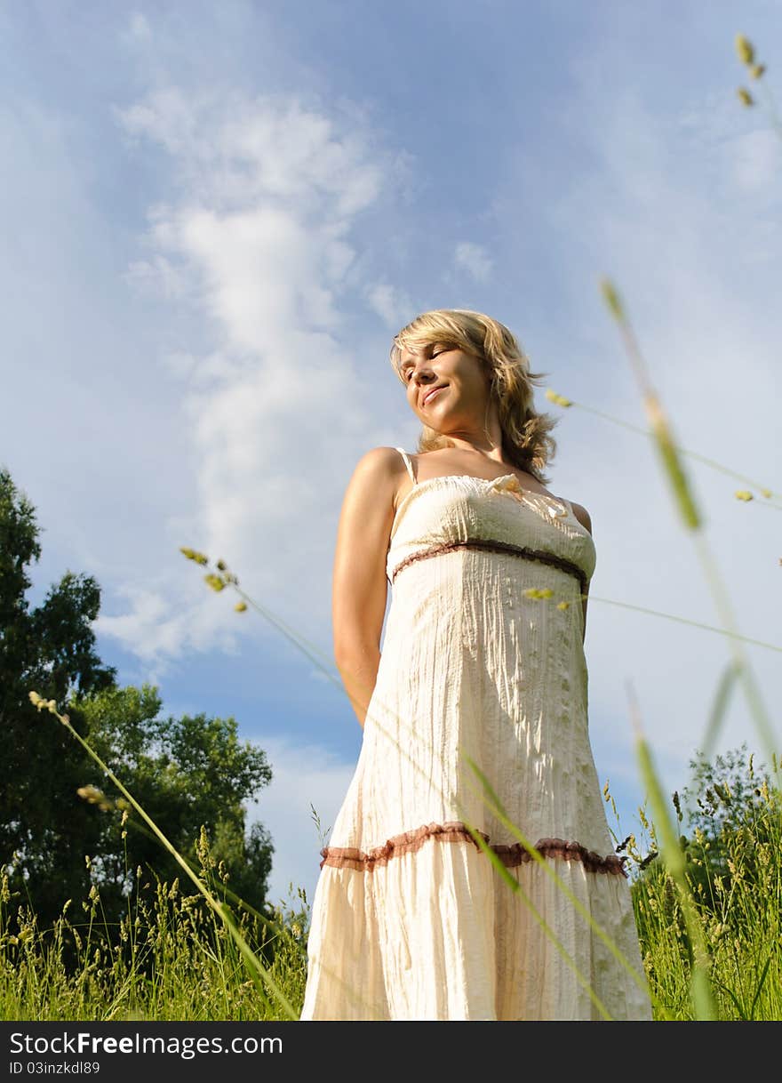 Young beautiful woman on the green meadow. Young beautiful woman on the green meadow