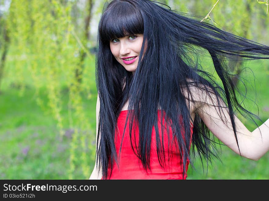 Beautiful woman with long hair at the park