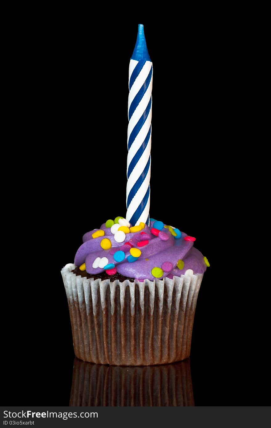 Cupcake with candle over wblack background