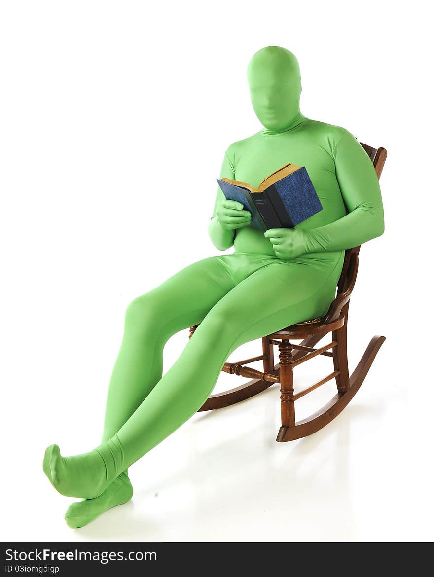 A green morphed man reading a book in a rocking chair. Isolated on white. A green morphed man reading a book in a rocking chair. Isolated on white.