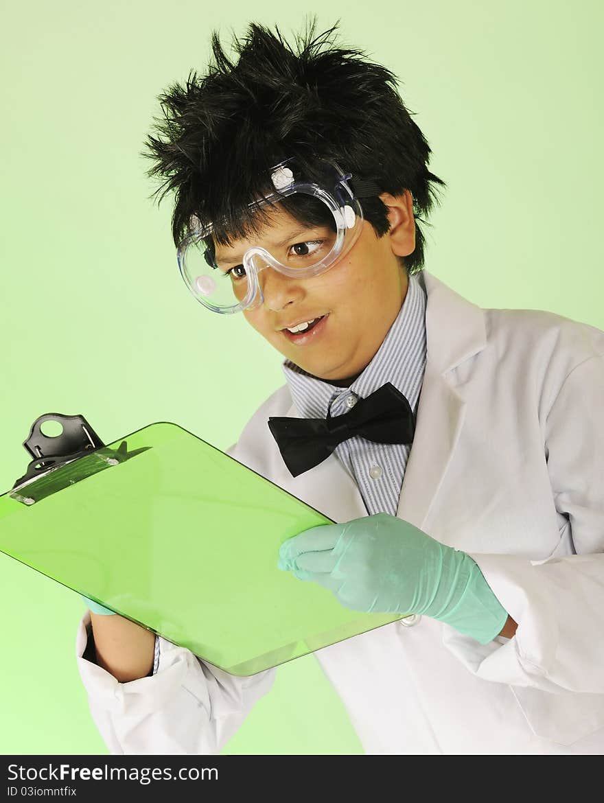 A young mad scientist in protective garb taking notes on a green clipboard. A young mad scientist in protective garb taking notes on a green clipboard.