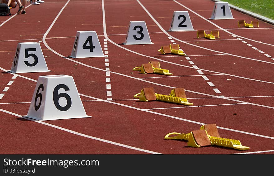 Yellow startingblocks on a red track. Yellow startingblocks on a red track