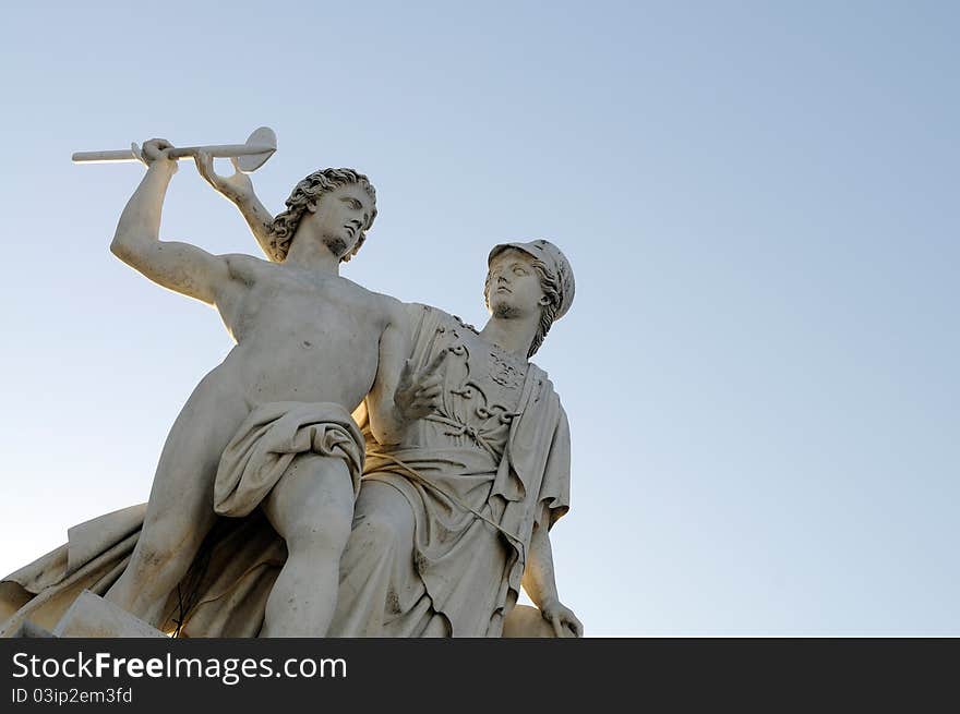 Athena teaches the young man how to use a weapon. This is one of eight statues on Schlossbruecke in Berlin, Germany.