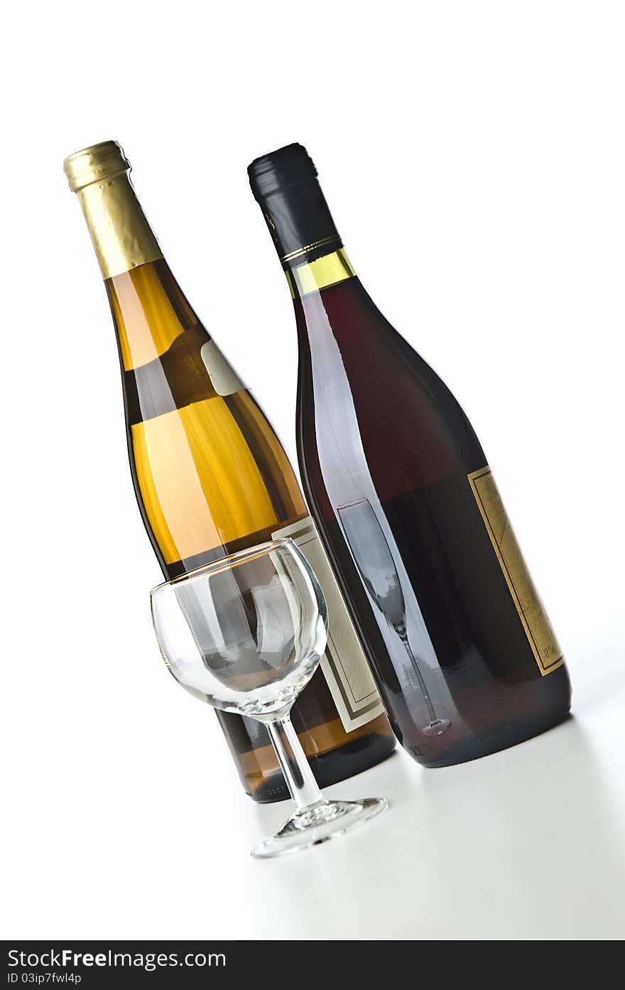 Two wine bottles and a glass