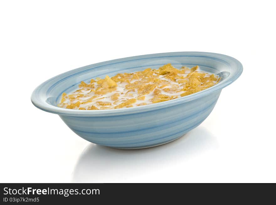 A bowl of cornflakes on a white background. A bowl of cornflakes on a white background