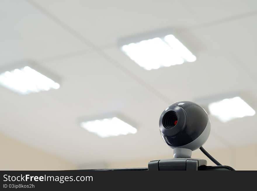 Digital web camera and office lights at the background