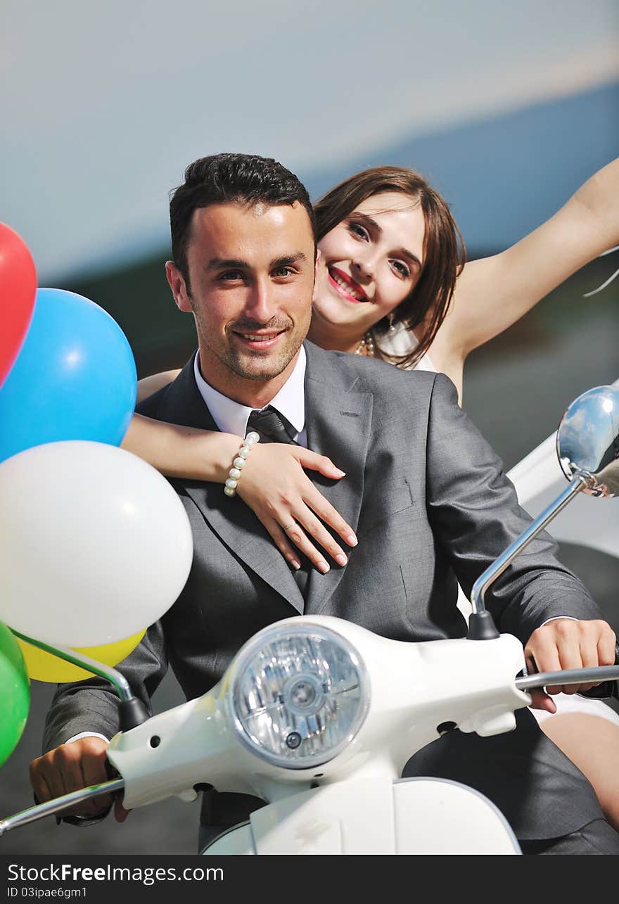 Wedding sce of bride and groom just married couple on the beach ride white scooter and have fun. Wedding sce of bride and groom just married couple on the beach ride white scooter and have fun