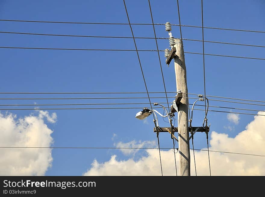 Metallic electric pole with a complex network of power cables running through it on sky background. Metallic electric pole with a complex network of power cables running through it on sky background.