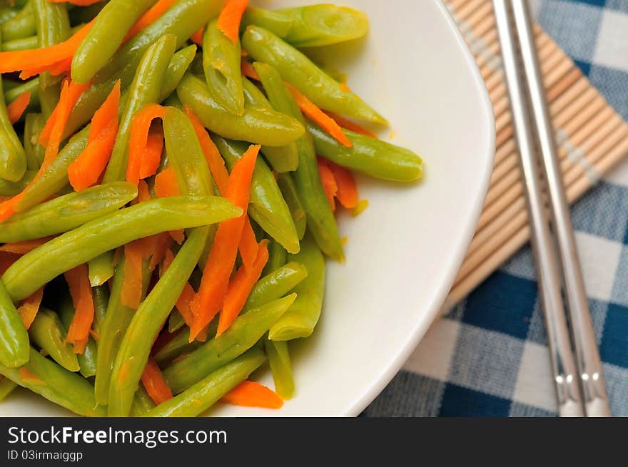 Chinese long beans cooked with carrot slices.