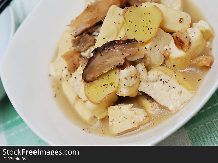 Closeup shot of Chinese style bean curd cuisine topped with black pepper.