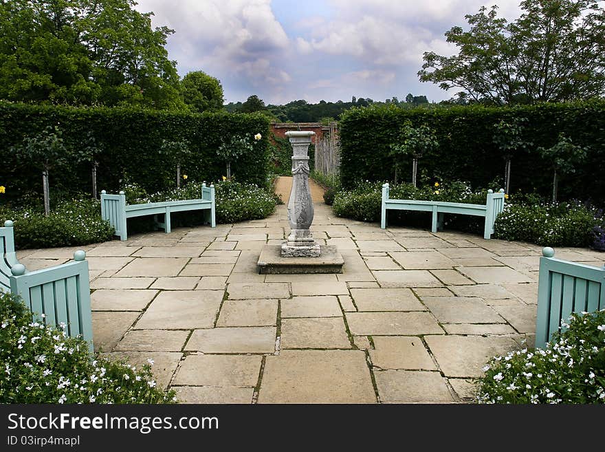 This is a country garden with a sundial as the centrepiece. This is a country garden with a sundial as the centrepiece.