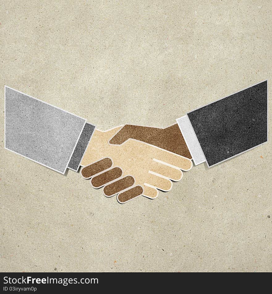 Shaking hands recycled paper craft stick on paper background