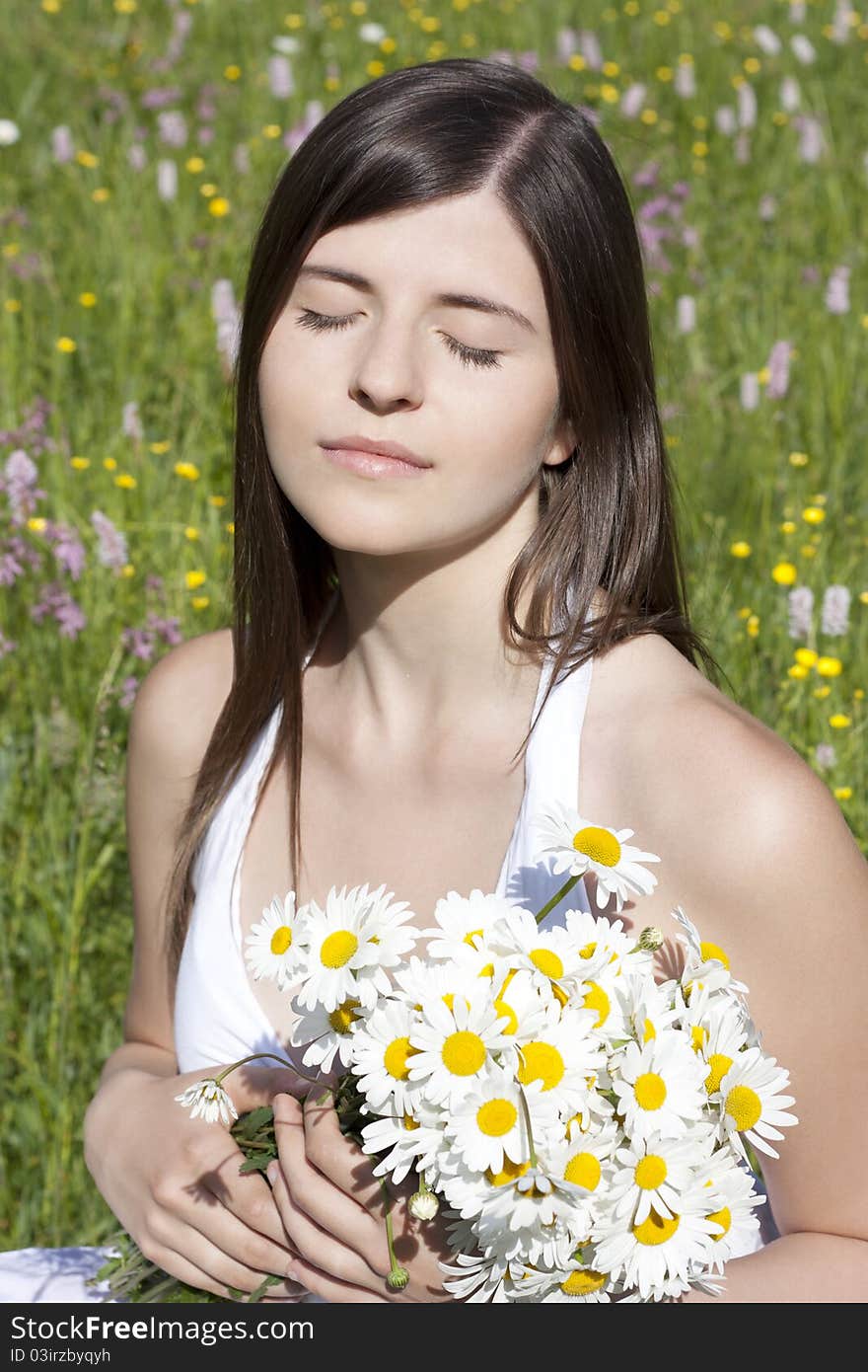 Portrait Of A Beautiful Girl Holding Flowers