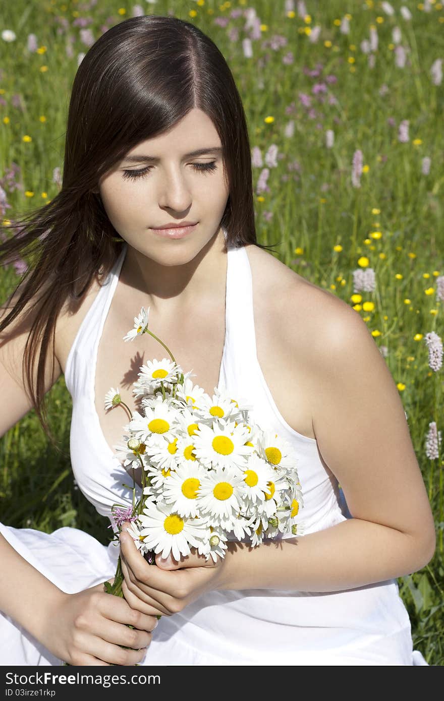 Portrait of a beautiful girl holding flowers