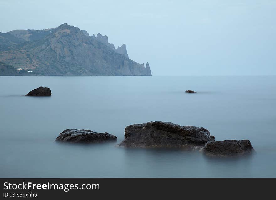 Evening over Black sea nad stones in the water