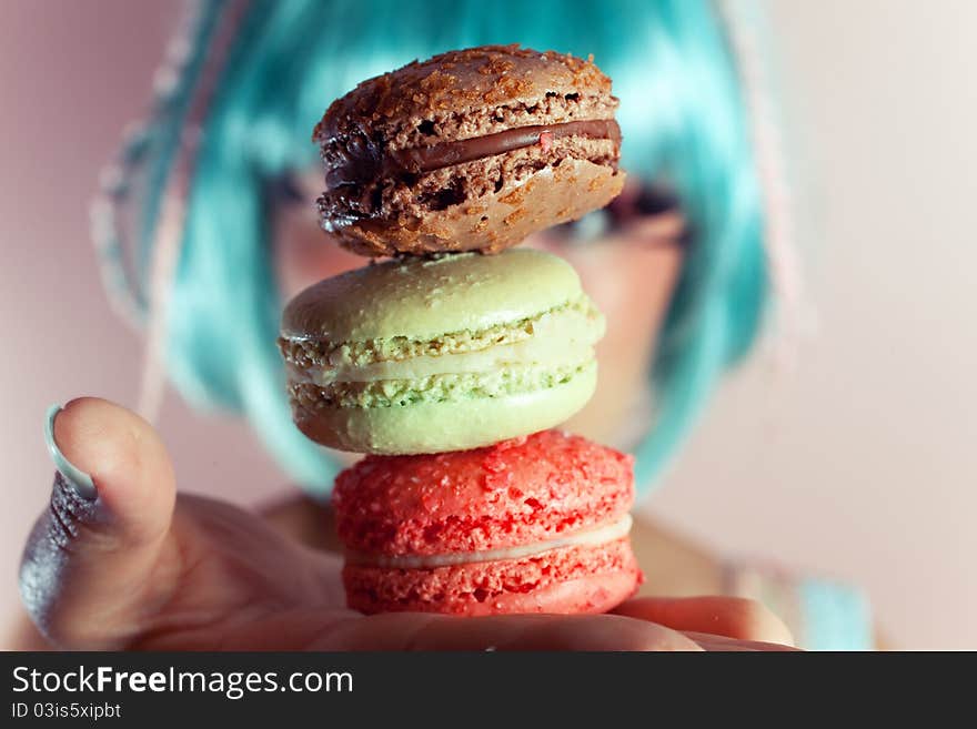 A young woman loves her sweet macaron. A young woman loves her sweet macaron.