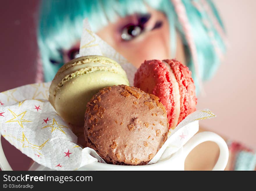 A young woman loves her sweet macaron. A young woman loves her sweet macaron.