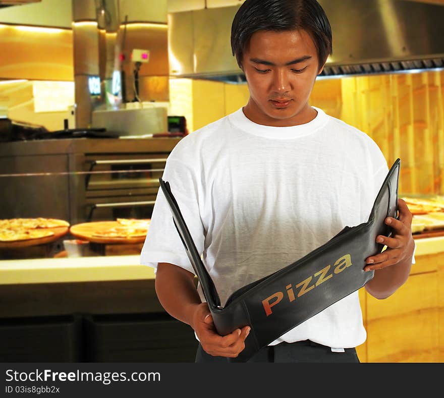 Diner Selecting Food From The Pizza Menu At A Pizzeria