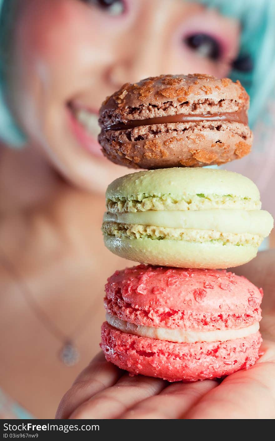 A young woman loves her sweet macaron. A young woman loves her sweet macaron.