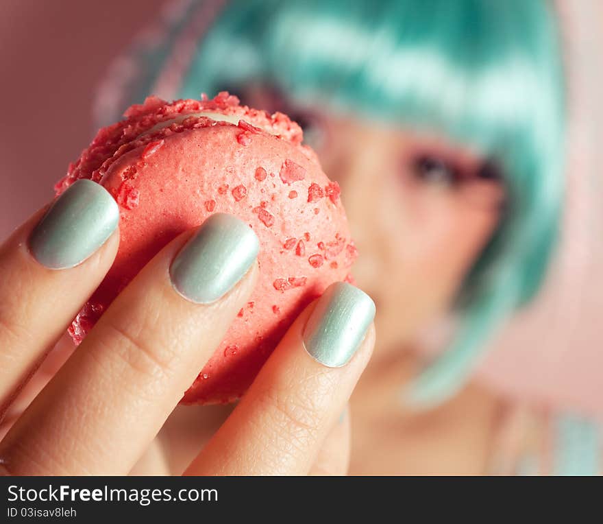 A young woman loves her sweet macaron. A young woman loves her sweet macaron.