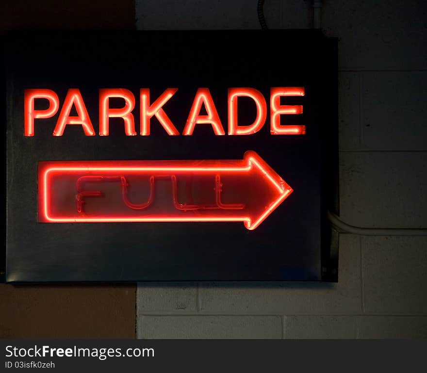 A neon sign indicating a parkade