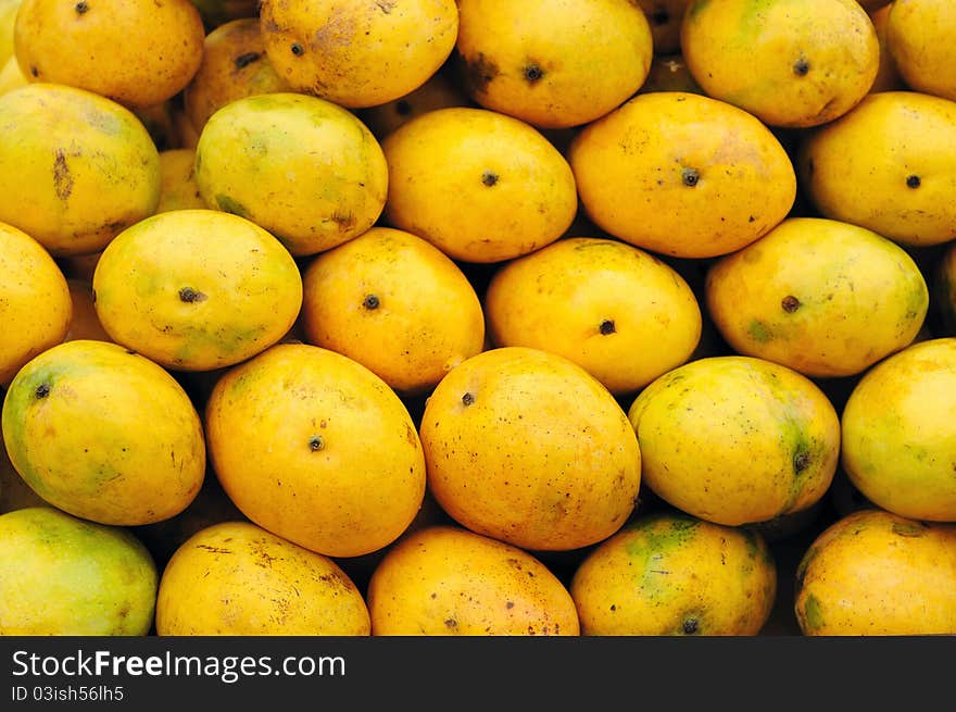 Closeup of ripe mangoes beautifully arranged for sale. Closeup of ripe mangoes beautifully arranged for sale