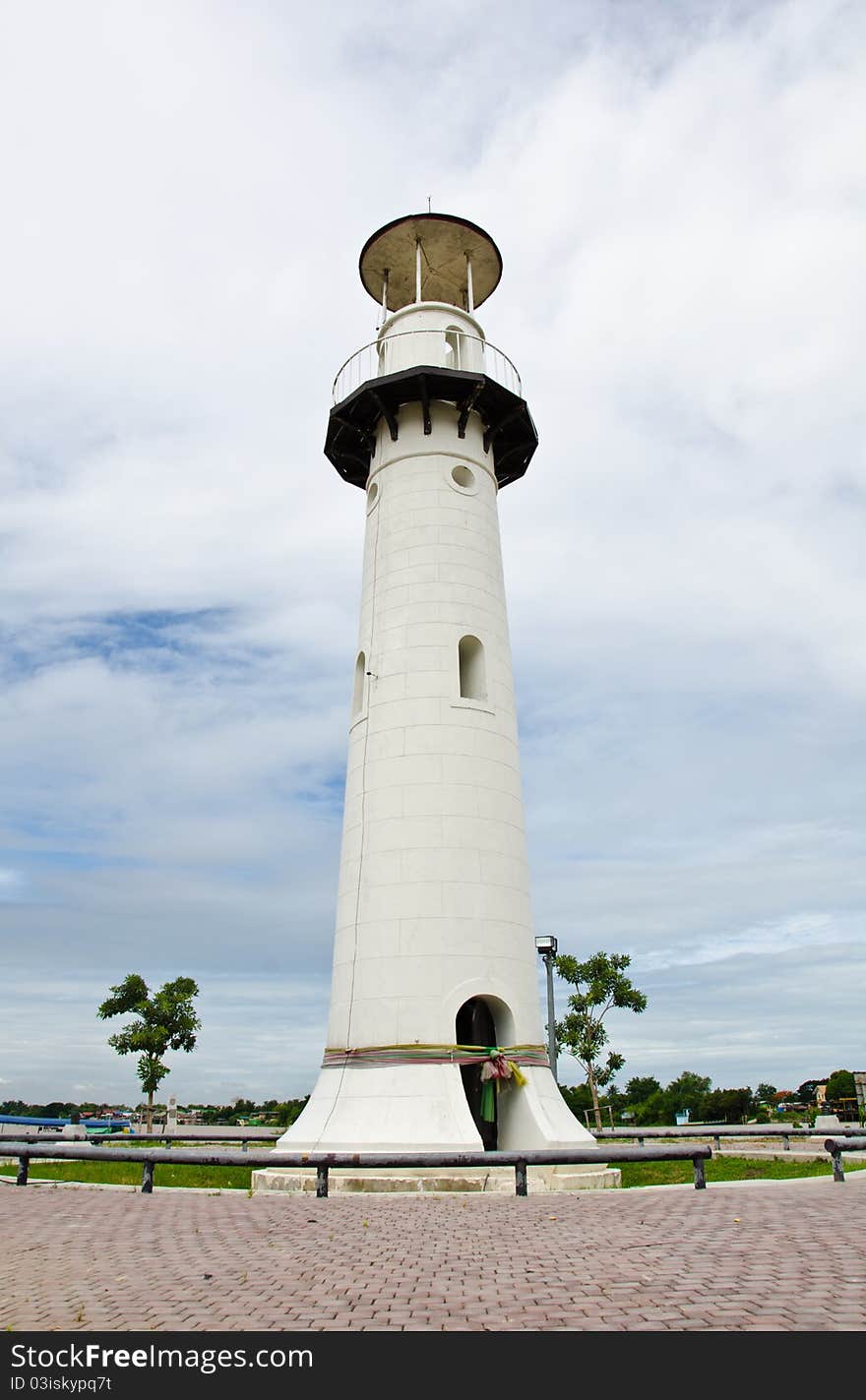 White lighthouse on the island in the middle river. Ayutthaya, Thailand. White lighthouse on the island in the middle river. Ayutthaya, Thailand.