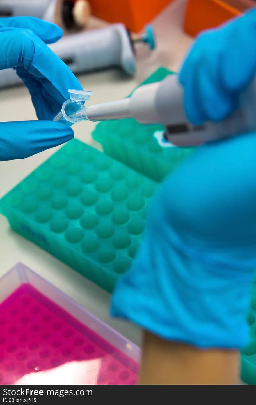 Pipette with drop of liquid in test tube