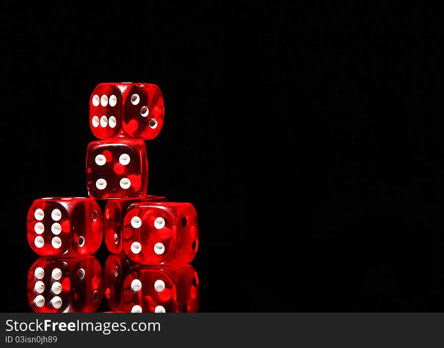 Red playing dices on black background