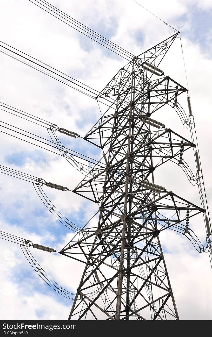 High voltage power line on blue cloudy sky